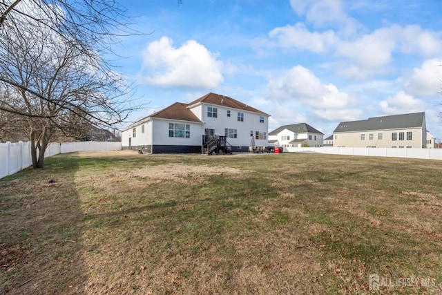 back of property with a lawn