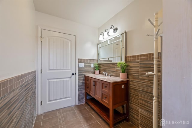 bathroom featuring tile walls, tile patterned floors, and vanity