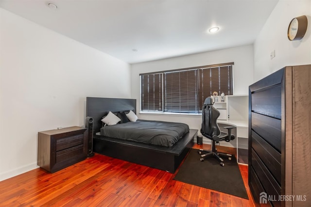 bedroom with hardwood / wood-style flooring