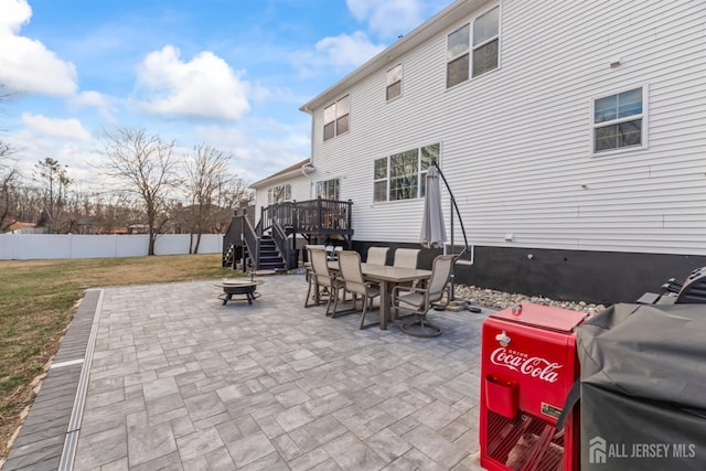 view of patio with a wooden deck and a fire pit