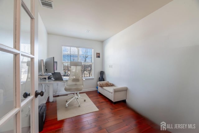 home office with dark hardwood / wood-style flooring