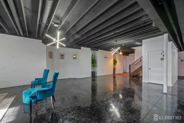 basement featuring an inviting chandelier