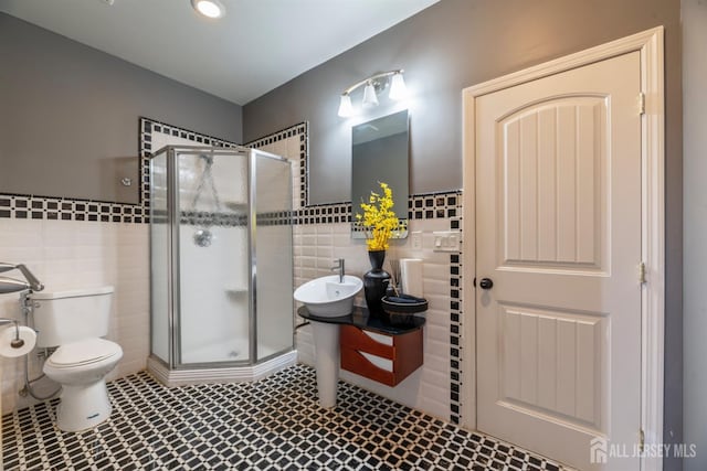 bathroom featuring tile walls, toilet, walk in shower, and vanity