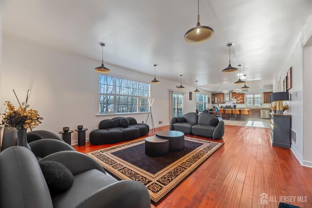 living room with plenty of natural light, hardwood / wood-style floors, and lofted ceiling