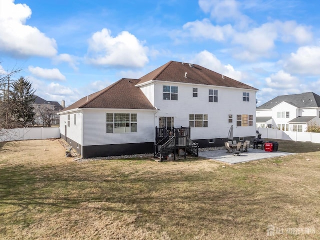 rear view of house featuring a yard and a patio