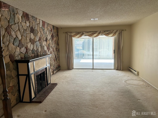 unfurnished living room with carpet flooring, a fireplace, a textured ceiling, and a baseboard heating unit