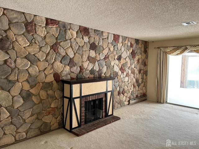 room details featuring visible vents, a fireplace with raised hearth, a textured ceiling, carpet flooring, and a baseboard radiator