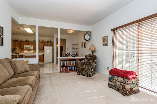 living area with light tile patterned flooring and light colored carpet