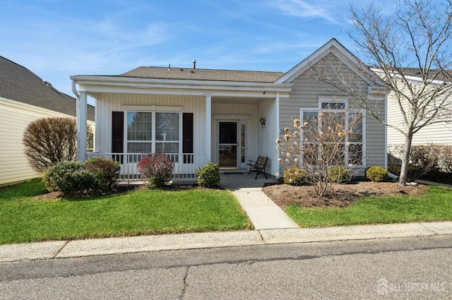 view of front of house featuring board and batten siding, a porch, and a front lawn