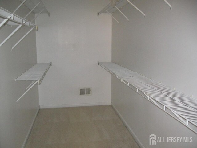 spacious closet featuring visible vents