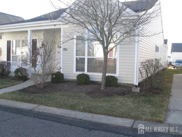 view of side of home featuring a lawn