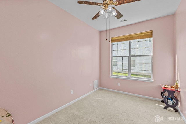 interior space featuring visible vents, ceiling fan, light carpet, and baseboards