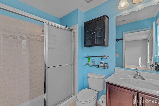 bathroom with visible vents, a stall shower, vanity, and toilet