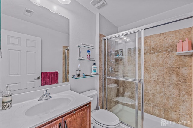 bathroom with toilet, a stall shower, and visible vents