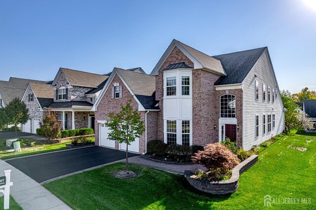 view of front of house featuring a garage and a front yard