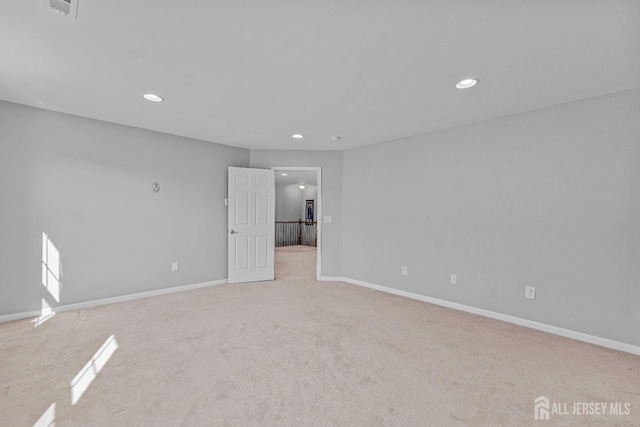 empty room featuring baseboards and recessed lighting