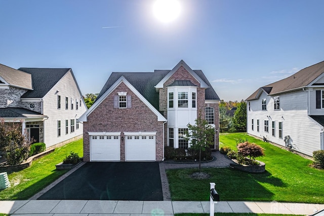 view of front of home featuring a garage and a front yard