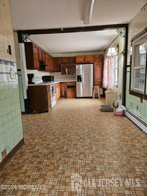 kitchen with decorative backsplash, appliances with stainless steel finishes, decorative light fixtures, and beamed ceiling