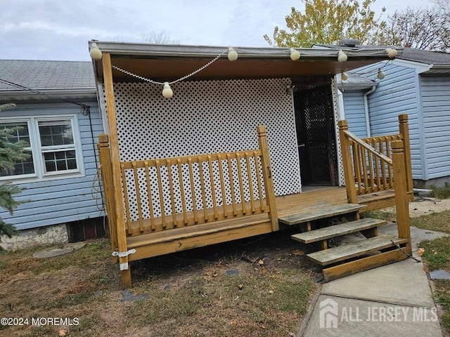 entrance to property with a deck