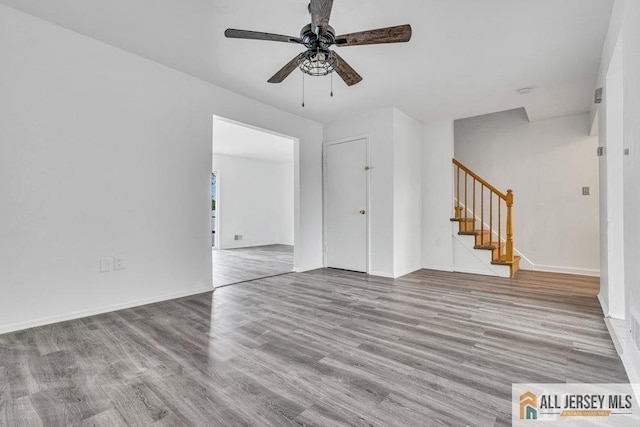 17 Begonia Ct, Sayreville, NJ 08872 - empty room featuring stairs, ceiling fan, and wood finished floors