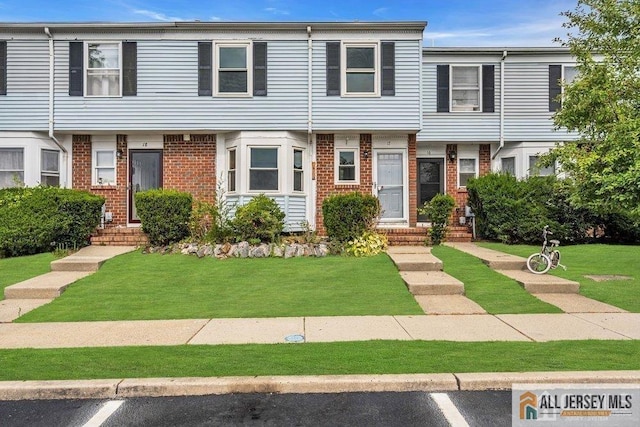 17 Begonia Ct, Sayreville, NJ 08872 - colonial home featuring brick siding, uncovered parking, and a front yard
