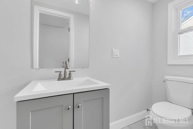 bathroom featuring toilet and vanity