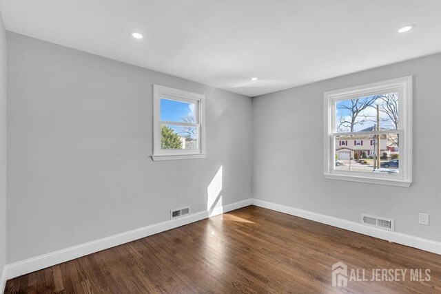 unfurnished room with hardwood / wood-style flooring