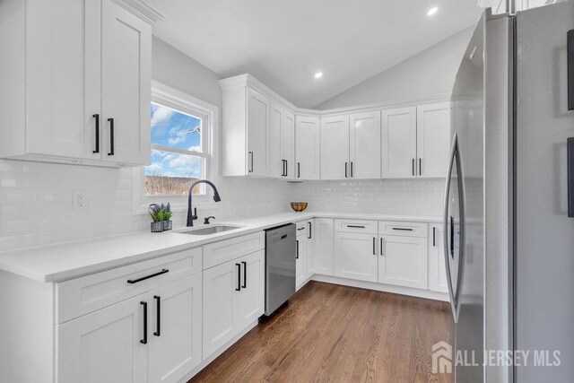 kitchen featuring white cabinets, appliances with stainless steel finishes, and sink