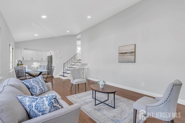 living room with hardwood / wood-style floors and vaulted ceiling