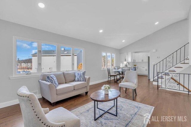 living room with lofted ceiling and hardwood / wood-style floors