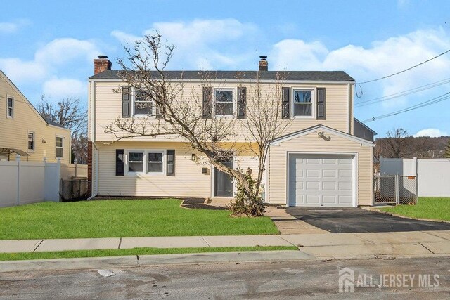 view of front property with a front lawn and a garage