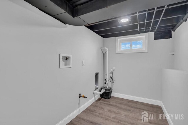 clothes washing area with hardwood / wood-style flooring, washer hookup, and gas dryer hookup