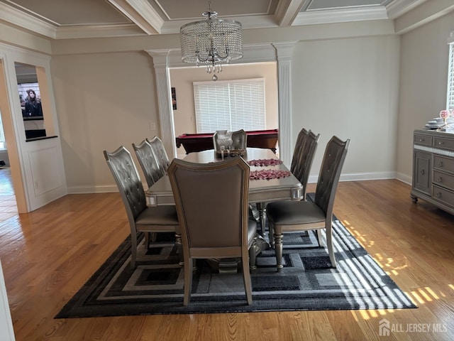 89 Sharot St, Carteret, NJ 07008 - dining room with decorative columns, a chandelier, ornamental molding, wood finished floors, and coffered ceiling