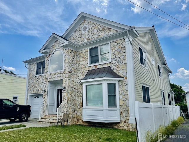 89 Sharot St, Carteret, NJ 07008 - view of front of house featuring stone siding, a standing seam roof, and a metal roof
