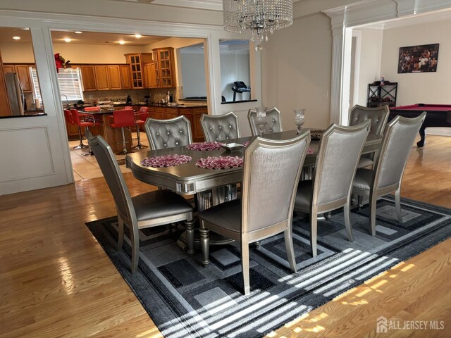 89 Sharot St, Carteret, NJ 07008 - dining area with light wood-style floors and a chandelier