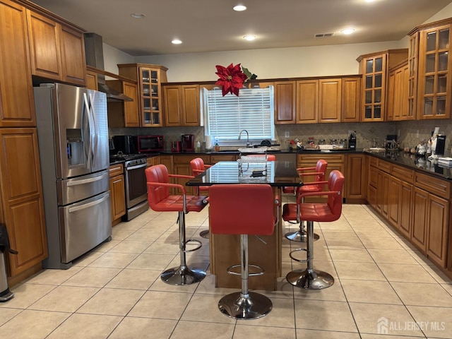89 Sharot St, Carteret, NJ 07008 - kitchen with stainless steel appliances, brown cabinetry, dark countertops, decorative backsplash, and recessed lighting