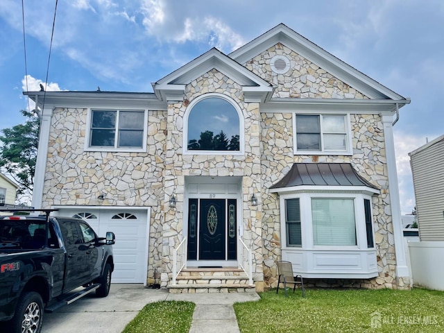 89 Sharot St, Carteret, NJ 07008 - view of front of house with an attached garage, a standing seam roof, entry steps, and stone siding