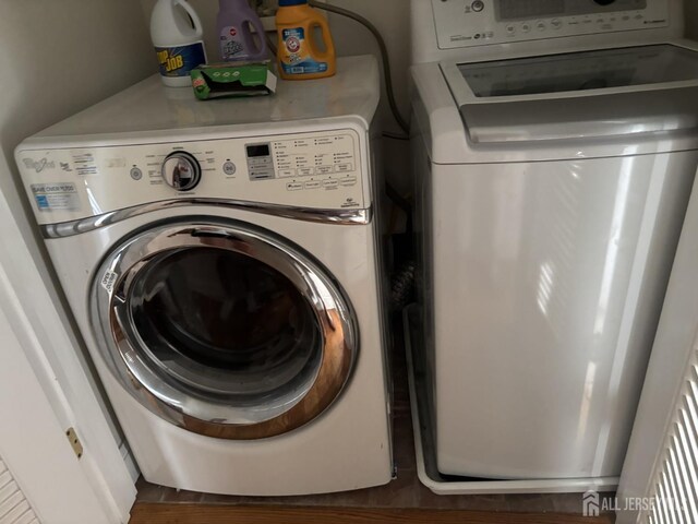 89 Sharot St, Carteret, NJ 07008 - laundry area with wood finished floors and separate washer and dryer