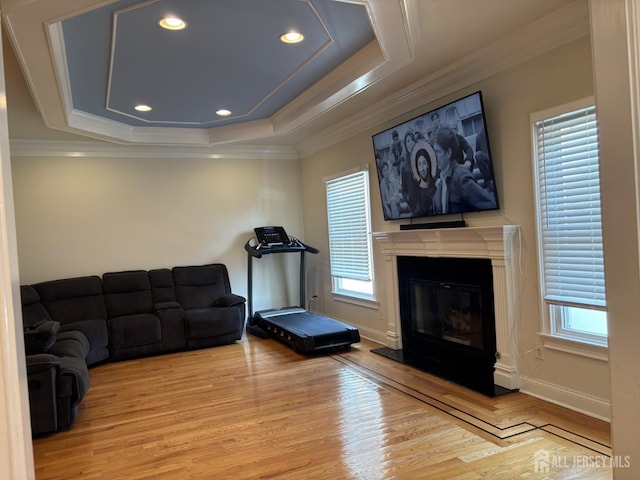 89 Sharot St, Carteret, NJ 07008 - living room with light wood finished floors, ornamental molding, a raised ceiling, a glass covered fireplace, and recessed lighting
