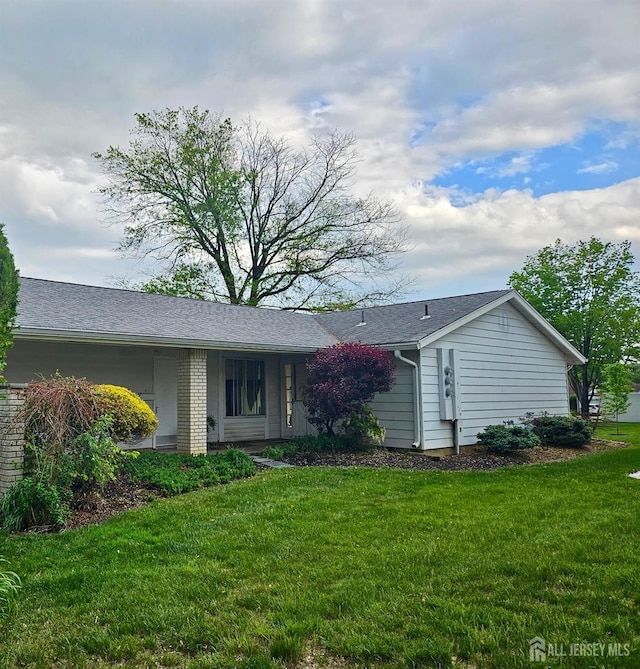 ranch-style home with brick siding and a front yard