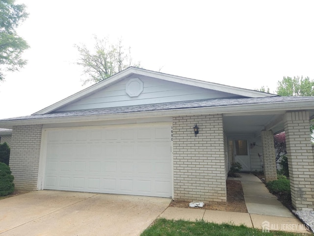 view of side of property featuring concrete driveway and brick siding