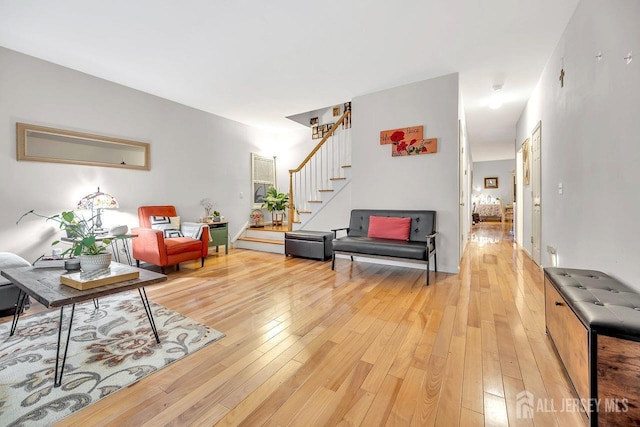 living area featuring light wood-type flooring and stairway