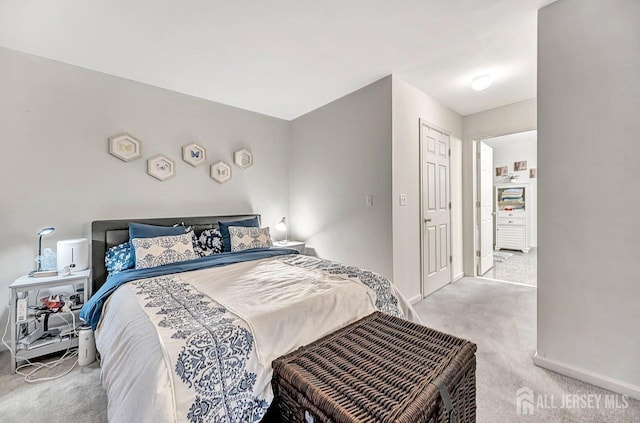 bedroom with light carpet and baseboards