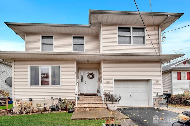 view of front of home with a garage and aphalt driveway