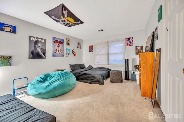 carpeted bedroom featuring visible vents