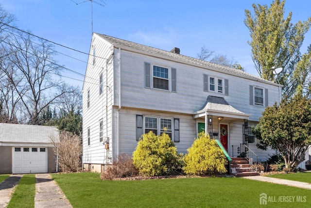 colonial home with driveway, a chimney, a front lawn, an outdoor structure, and a garage