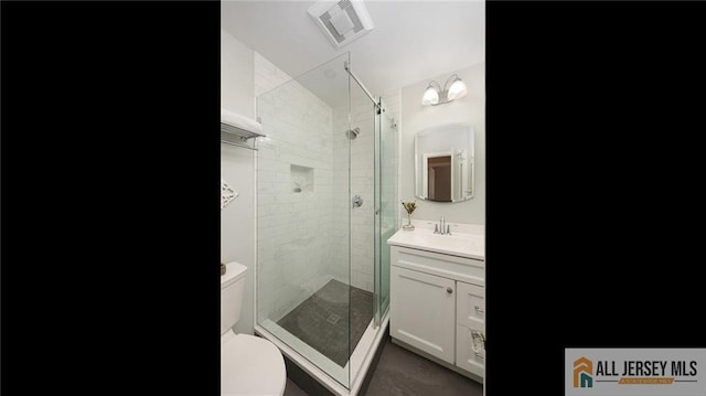 full bathroom with toilet, a stall shower, vanity, and visible vents