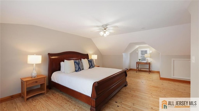 bedroom with baseboards, light wood finished floors, ceiling fan, and lofted ceiling