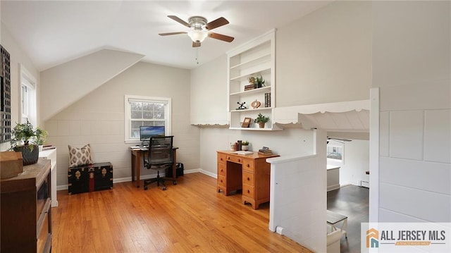 office space with light wood-style flooring, ceiling fan, vaulted ceiling, and baseboard heating