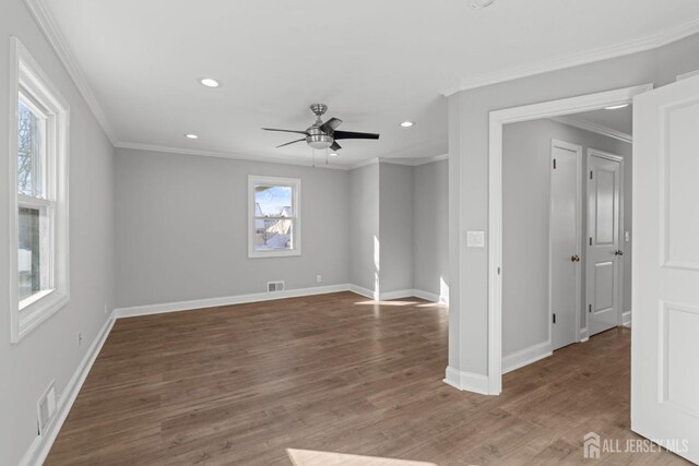 unfurnished room with hardwood / wood-style flooring, ceiling fan, and crown molding